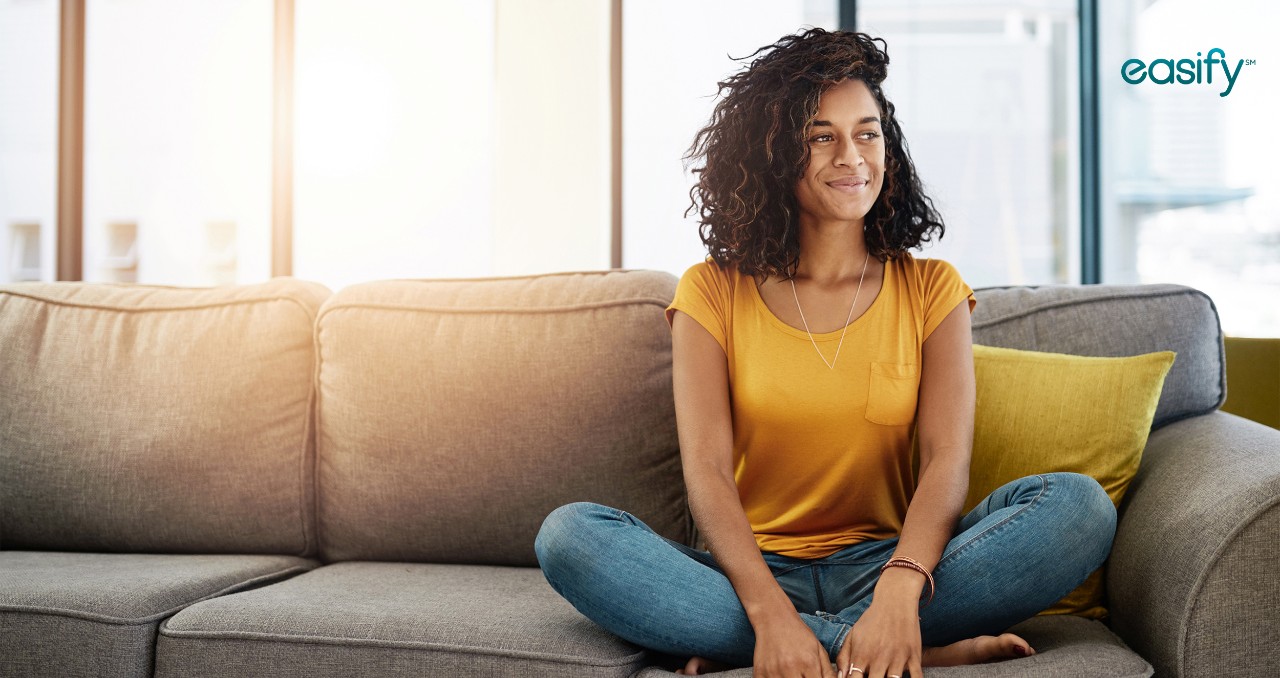 A woman sits on a couch with Easify logo in corner