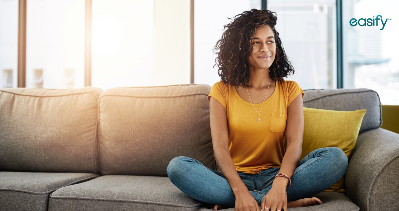 A woman sits on a couch with Easify logo in corner