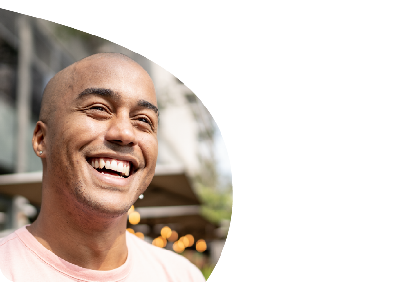 A man smiling into the sky. 