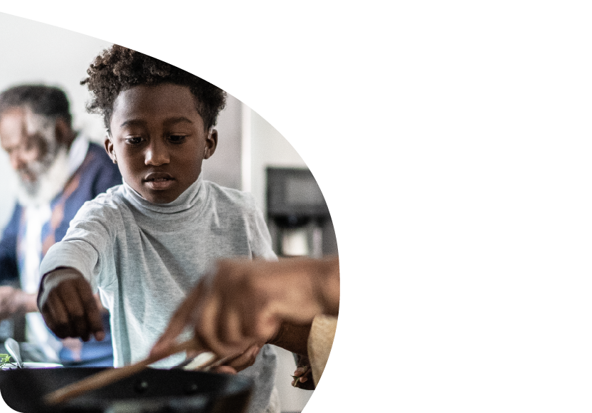 A young child helping cook. 