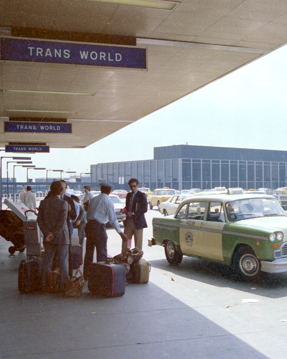 HCSC- travelers unloading luggage at airport. 