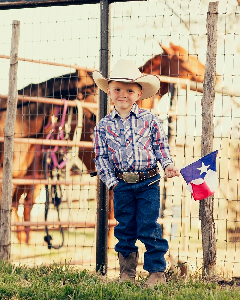 HCSC- A young cowboy is proud to display the flag of Texas.