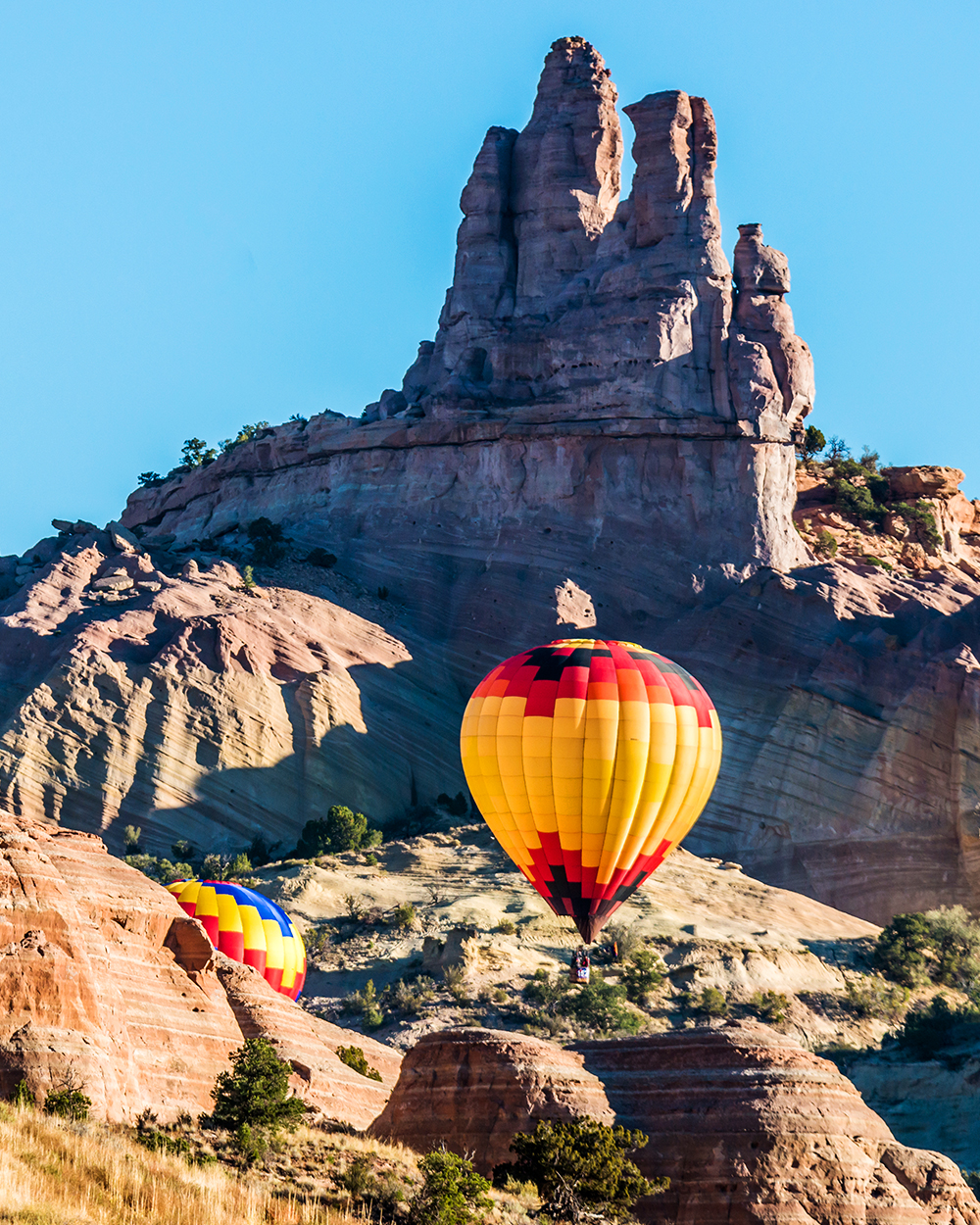 HCSC- Hot air balloons flying over Castle Rock in the Red Rock Canyon near Gallup, New Mexico.