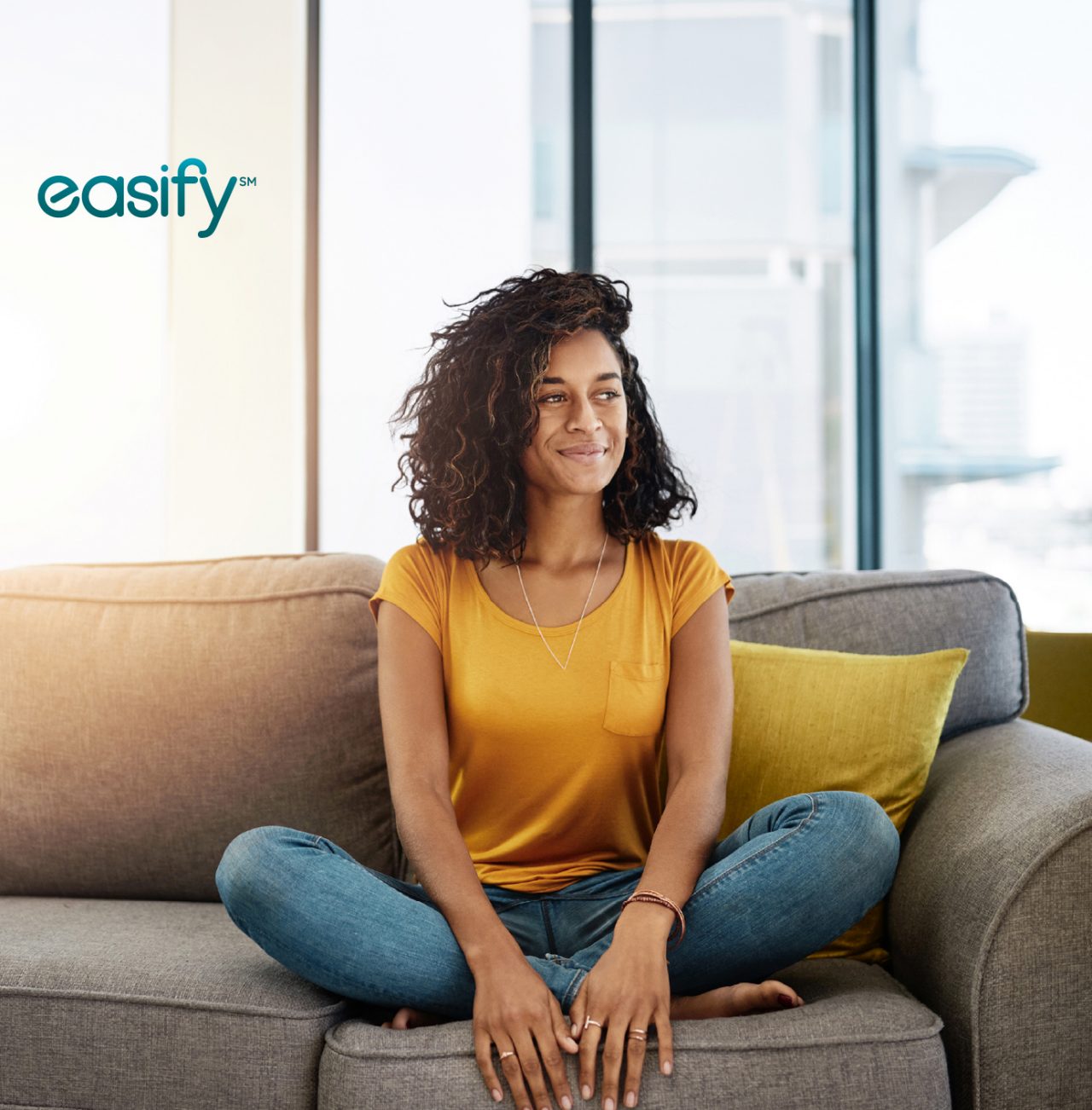 A woman sits on a couch with Easify logo in corner