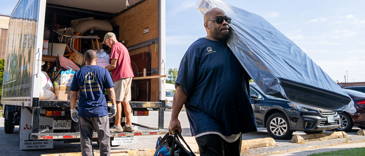 Mover unloads furniture from truck