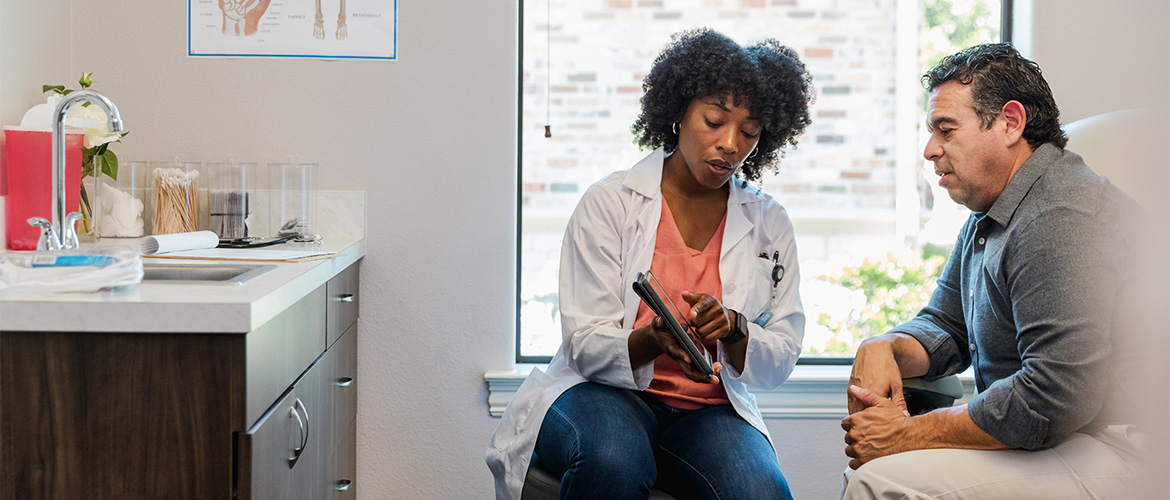 A health care provider discusses health outcomes with a patient