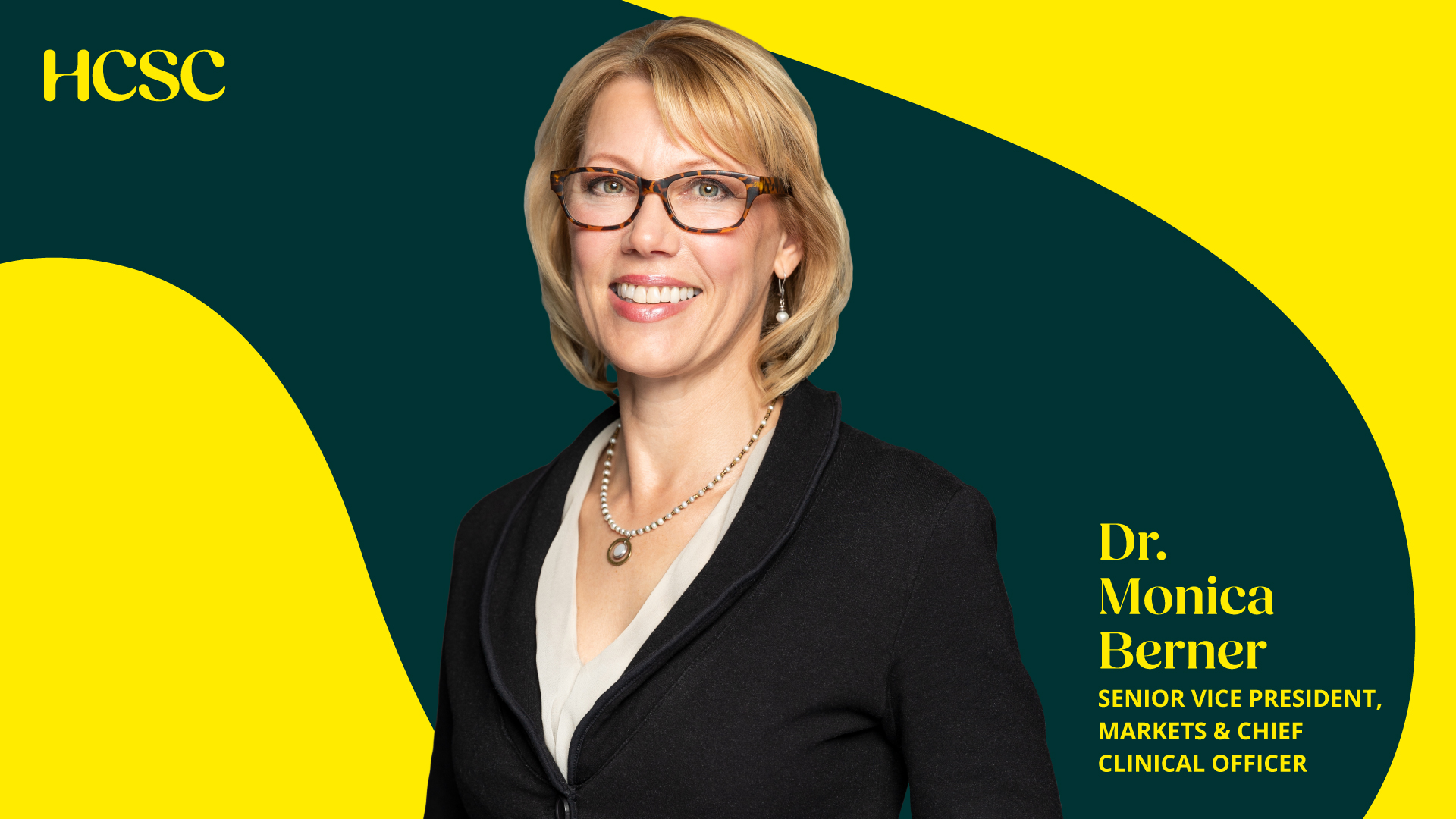 business woman in suit and glasses smiles